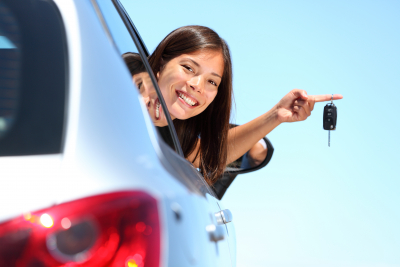 portrait of woman inside the car holding a key